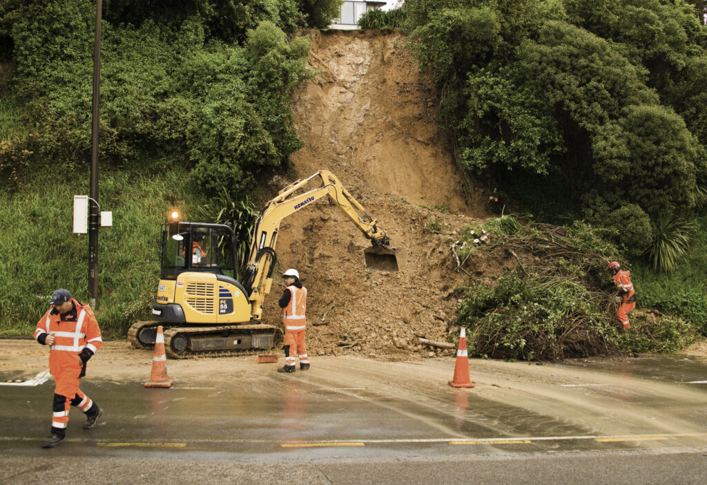 Contractors clear road after slip.