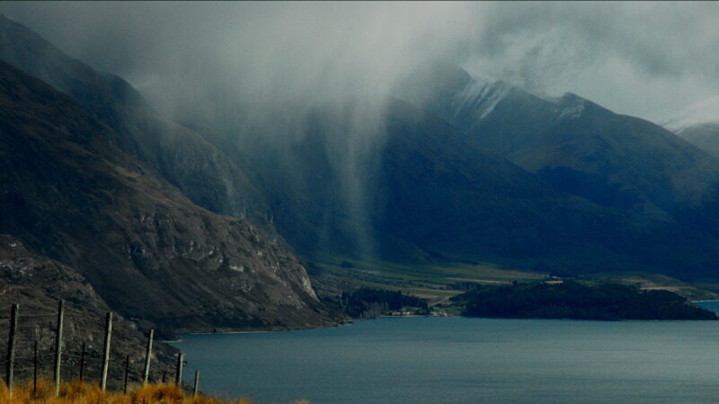 Rain and clouds coming over a mountain