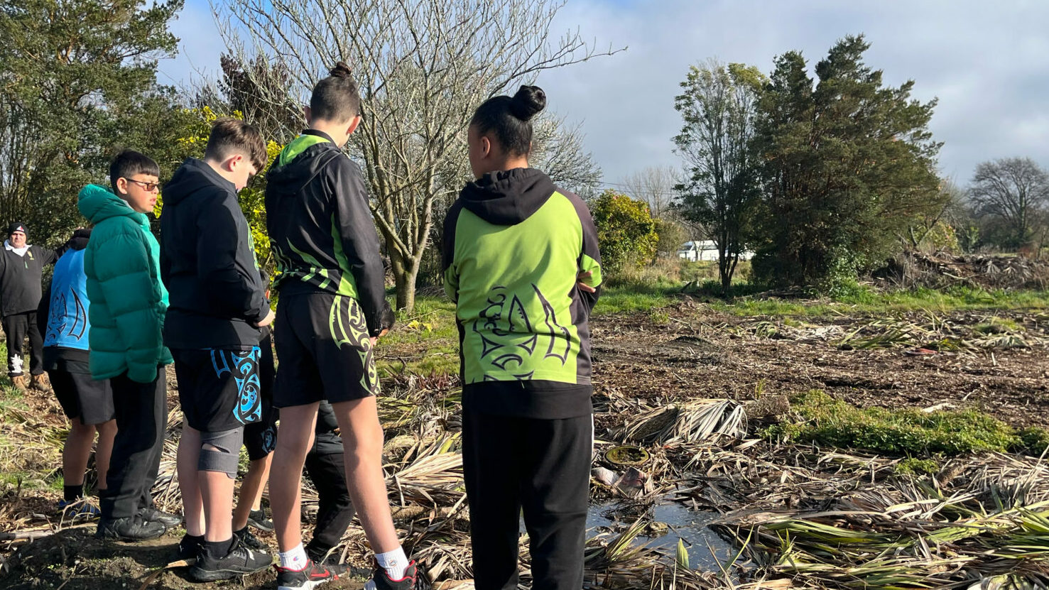 A group of young people looking over an area after a flood